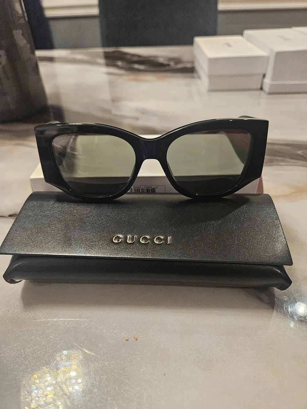 Gucci Black Cat-Eye Sunglasses with Green-Tinted Lenses